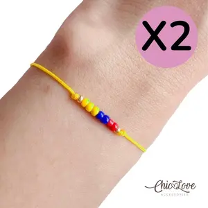 X 2 Colombian thin yellow nylon bracelets with colored beads, Features small yellow, blue and red beads for a clean and lightweight look.