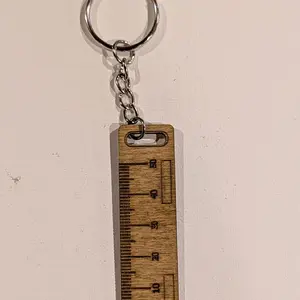 Ruler keychain with markings.