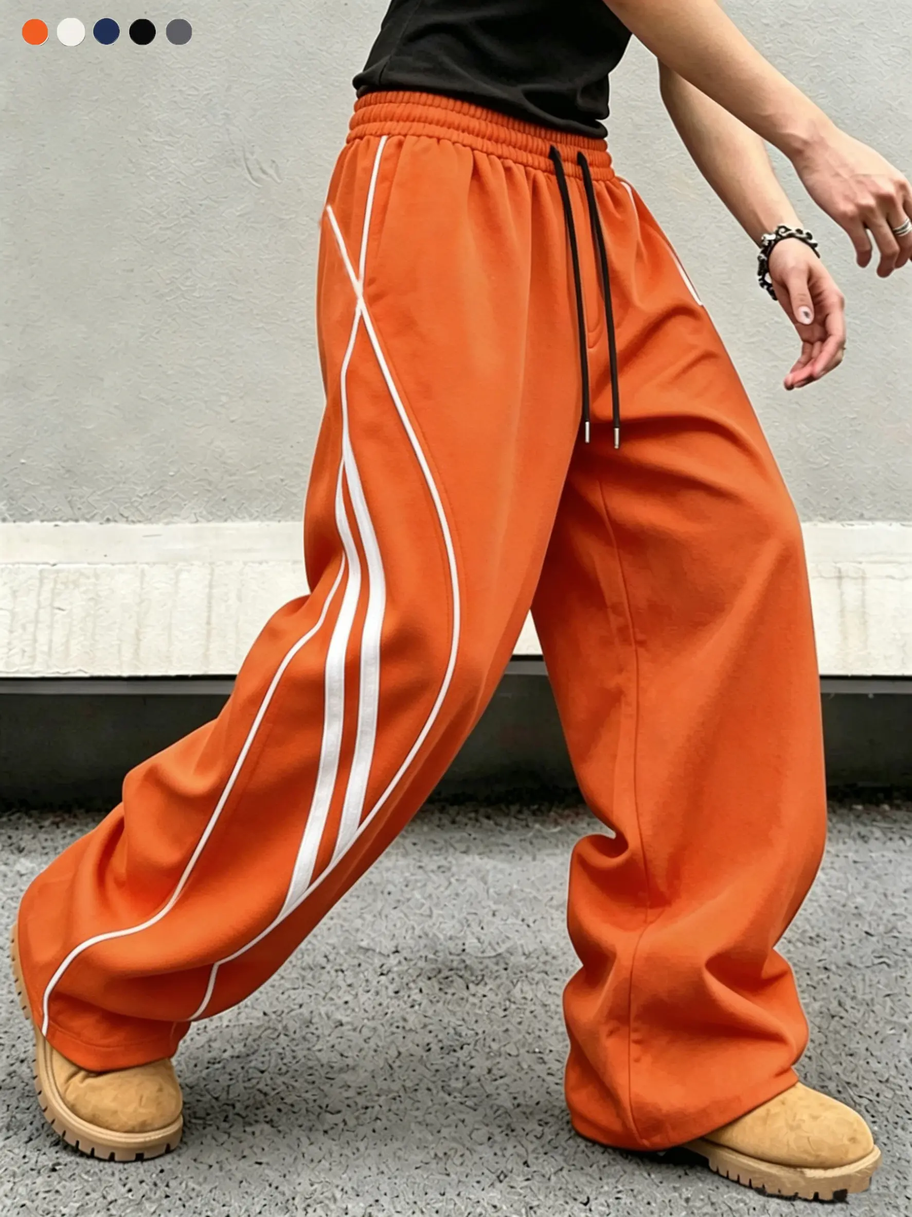 Men’s orange striped athletic pants — street style, sporty casual fit, elastic waistband, loose wide-leg cut. A must for gym workouts and music festivals. High saturation bright color. Street trend style, Y2K retro striped wide-leg pants.