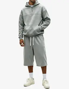 Men’s half-zip hooded sweatshirt and 3/4 pants set, available in two colors, featuring a relaxed drop-shoulder design and soft fabric, suitable for everyday commuting, streetwear styling, and casual outings.