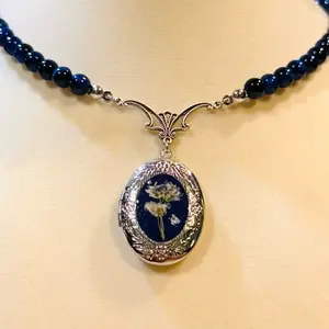 Iridessa Flower Locket Necklace with Blue Beads and Oval Pendant Featuring Floral Design