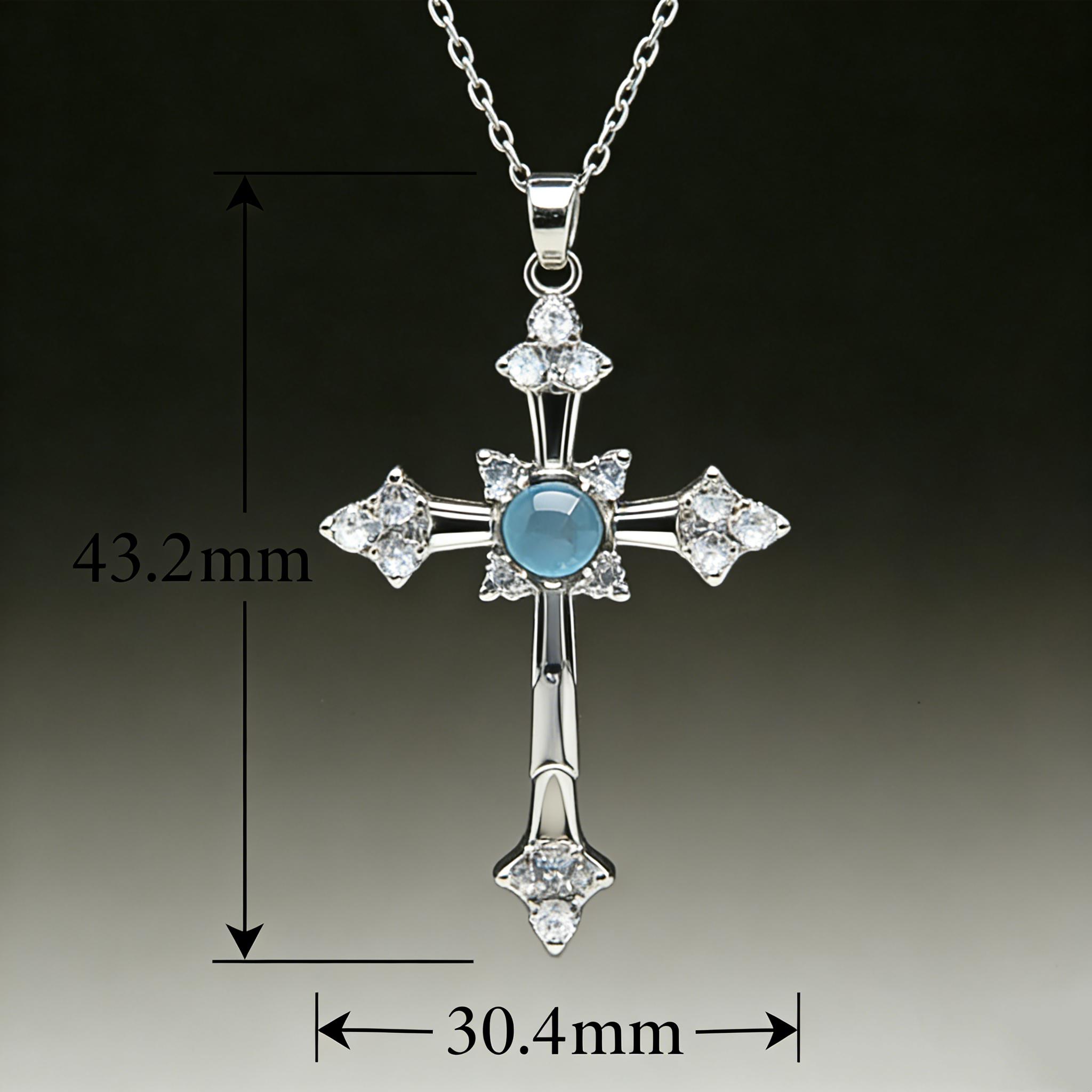 A cross necklace imbued with protective energy, featuring exquisitely set blue-white sapphires—blue gemstones—inspired by a designer’s original concept and conveying the Christian faith’s blessing of peace.