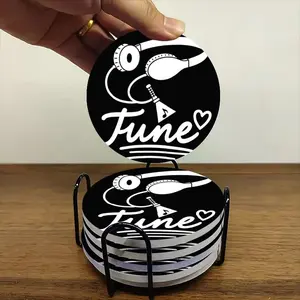 6-piece ceramic coaster set, featuring a minimalist design with black and white music headphones and musical notes. These heat-resistant, non-slip coasters come with a holder and are suitable for home, dining, and as beverage mats.
