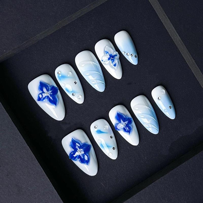 Blue Floral Press On Nails with 3D Flowers and Rhinestones – Icy White and Baby Blue Gradient Almond Nails. Artificial reusable trendy art.