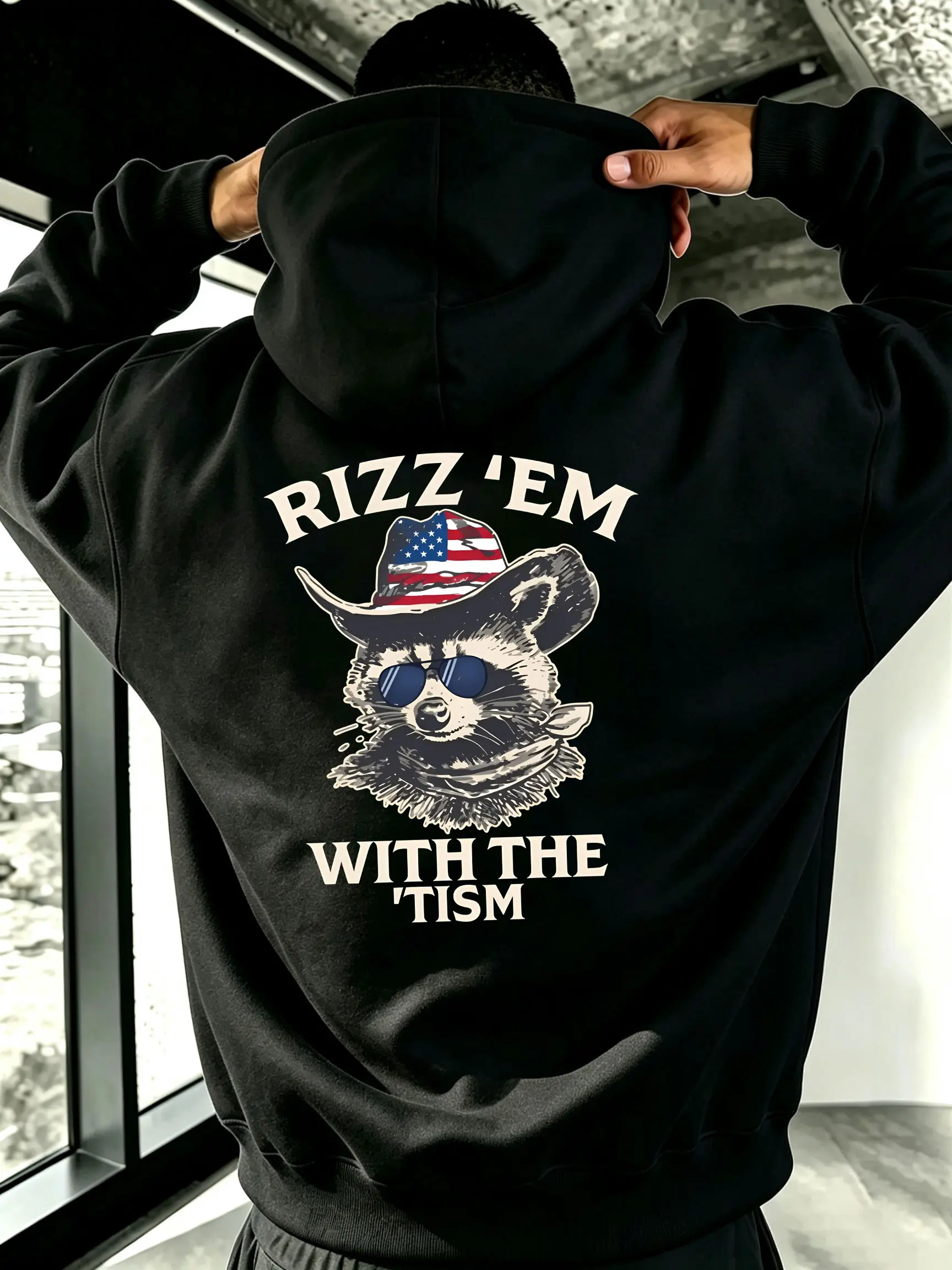 “Rizz ‘em with the ‘tism” American-style raccoon graphic hoodie sweatshirt, internet meme humor design, unisex oversized hoodie
