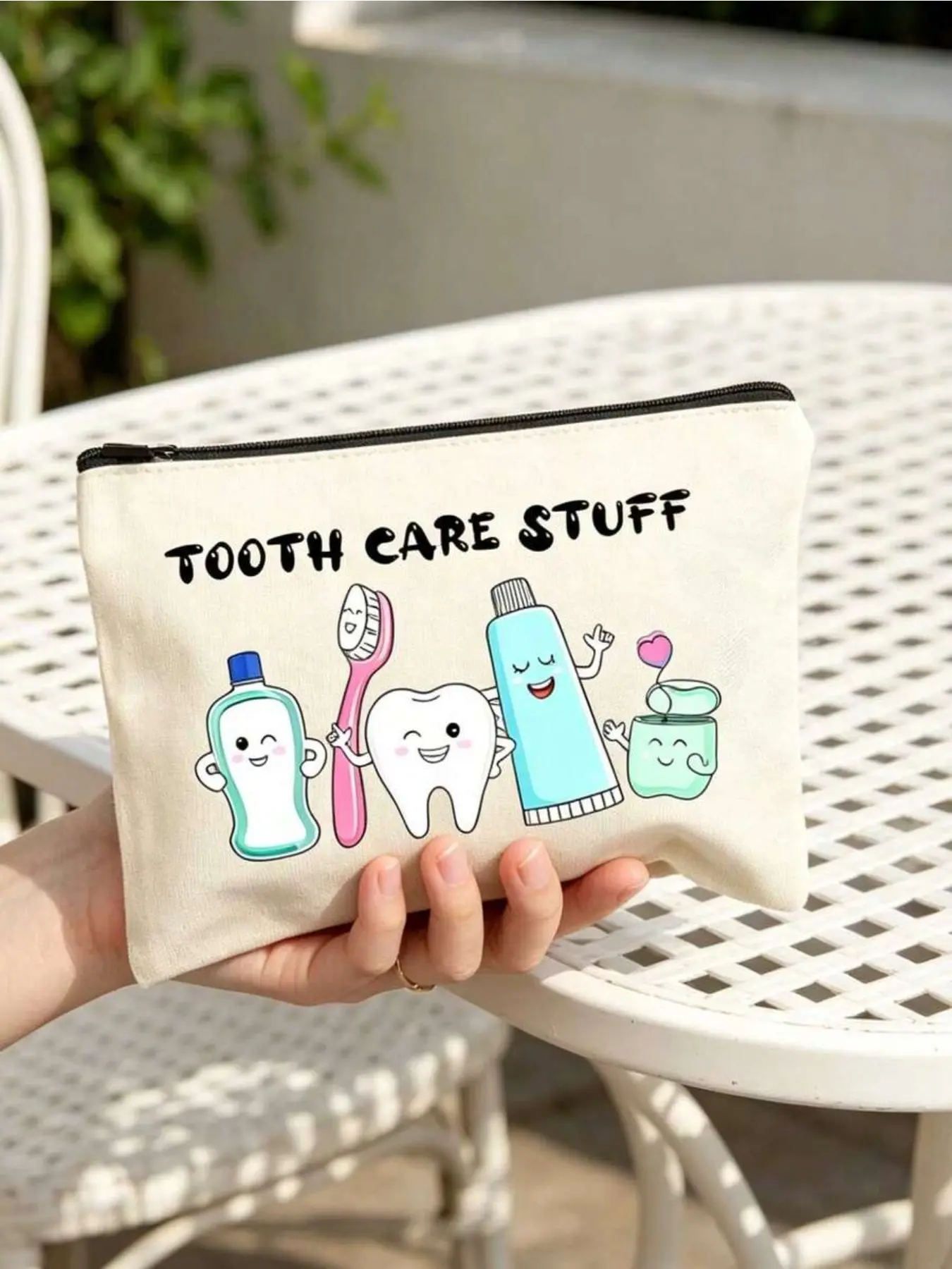Fun cartoon dental care makeup bag with zipper closure. Portable pouch stores toothbrushes, toothpaste and oral care supplies. Creative design for daily commute, travel and beach use. Great gift for dental hygienists and travel lovers.