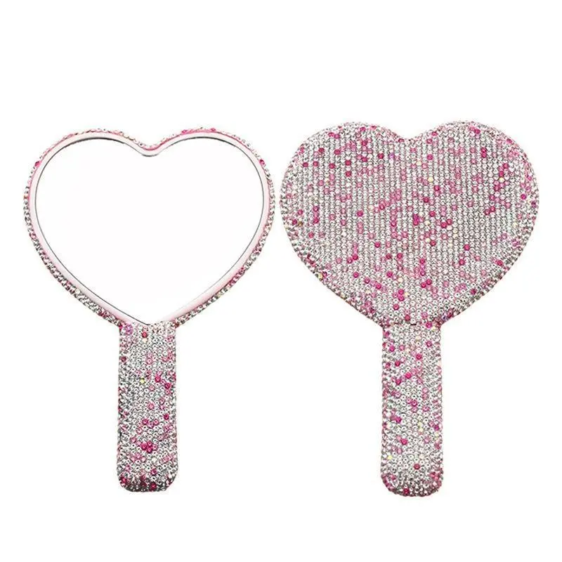 Diamond-encrusted handheld makeup mirror, portable and cute handle-style compact mirror, perfect for carrying on the go, featuring a trendy heart-shaped design.