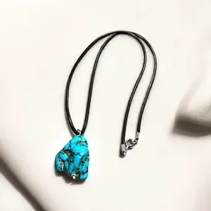 Beautiful turquoise stone pendant on a 22in leather necklace.