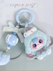 A Cute charms keychain, featuring a multi-colored plush doll paired with a bow and pom-pom, sweet and dreamy style, suitable for hanging on bags or keys, adding a girlish and lively atmosphere to everyday outings, dates