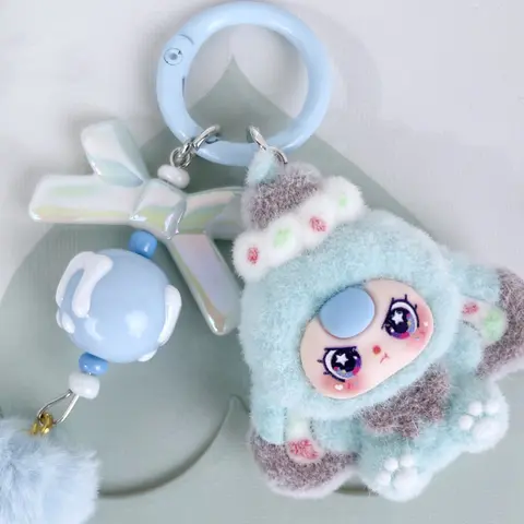 A cute pendant, Cute Keychain Kawaii, featuring a multi-colored plush doll, paired with a bow and pom-pom, suitable for hanging on bags or keys, adding a girlish and lively atmosphere to everyday outings and gatherings