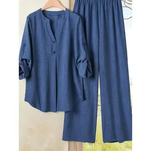 Elegant yet casual plus-size women’s two-piece set featuring a V-neck long-sleeve top and loose wide-leg pants, stylish for spring and autumn GARMENTARY