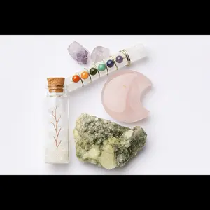 Assorted crystals . Clear quartz tree in a bottle, sphalerite palm stone , rose quartz moon, green tourma line & celenite chakra stick