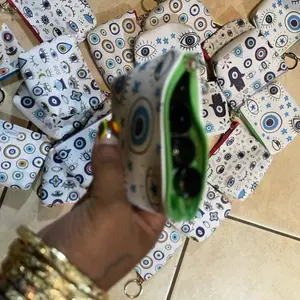 Eye Patterned Coin Purse with Zipper Closure and Green Interior for Everyday Use