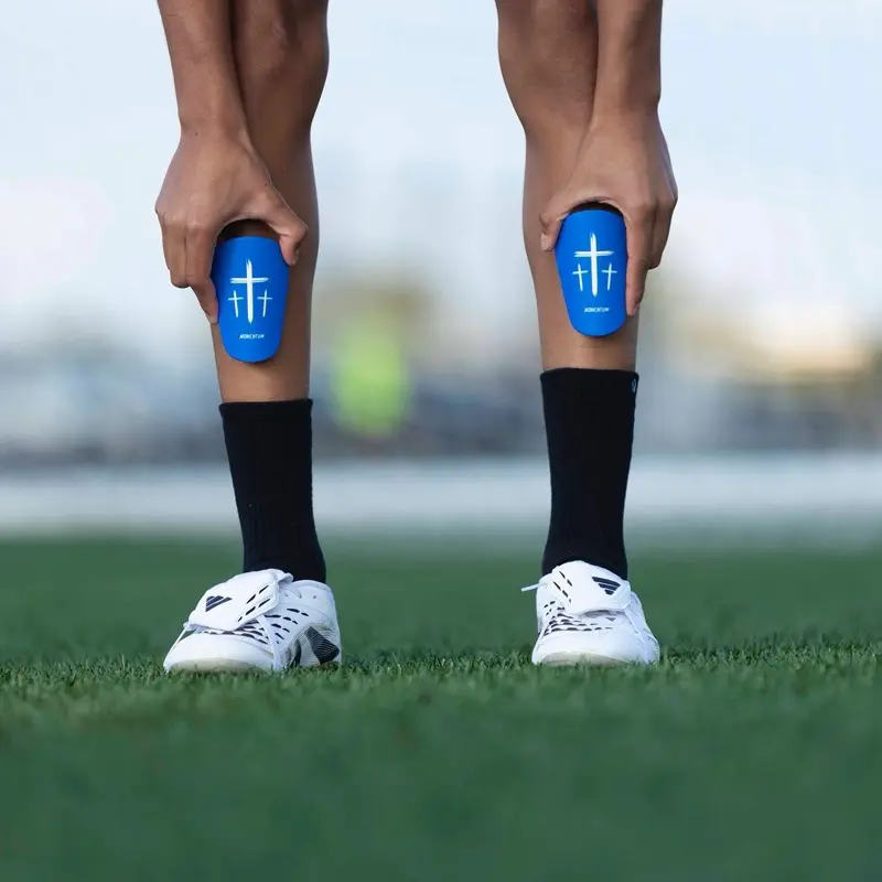 Momentum Blue Cross Shin Mini Guards 4x3in Minimalist Functional Safety Enhancing Performance Field Gear