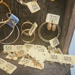 Gold-Tone Hoop Earrings Collection, Arranged on a Display Board