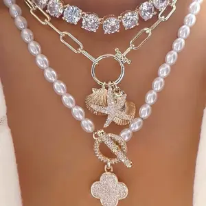 Shop The Look - 14k Gold Plated Starfish and Seashell Charm Necklace, 14k Gold Plated Cluster CZ Necklace and Pearl Pave Clover Toggle Necklace