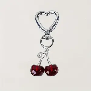 A stylish cherry shaped resin keychain phone pendant with cute metal accessories, Trendy Cute Keychain, making it an ideal gift for loved ones.