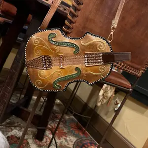 Small Bag with Unique Guitare Design and Soft Brown Leather.Can be also a small backpack. Hand painted, this bag is exquisite.