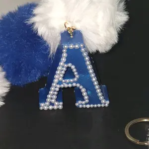 Blue Pearl-Adorned Letter A Keychain with White and Blue Pom-Poms for Stylish Accessories