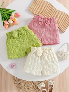 Three piece combination set of girls' summer shorts, with a fresh texture and bow style. The girls' pleated shorts feature a three-dimensional bow, bubble texture fabric, and multiple colors to choose from. It is suitable for daily home, summer outings