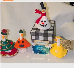 DESK GOOSE STARTER PACK. Includes Box, 4.5" Ceramic Dek Goose and four outfits. Raincoat, Pumpkin, Snowman and Christmas Tree and tree skirt.