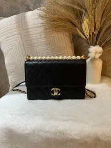 Pre-owned CHANEL Classic Flap Bag with pearl top handle, crafted in 2020. Features iconic diamond quilted black lambskin 1919H0100