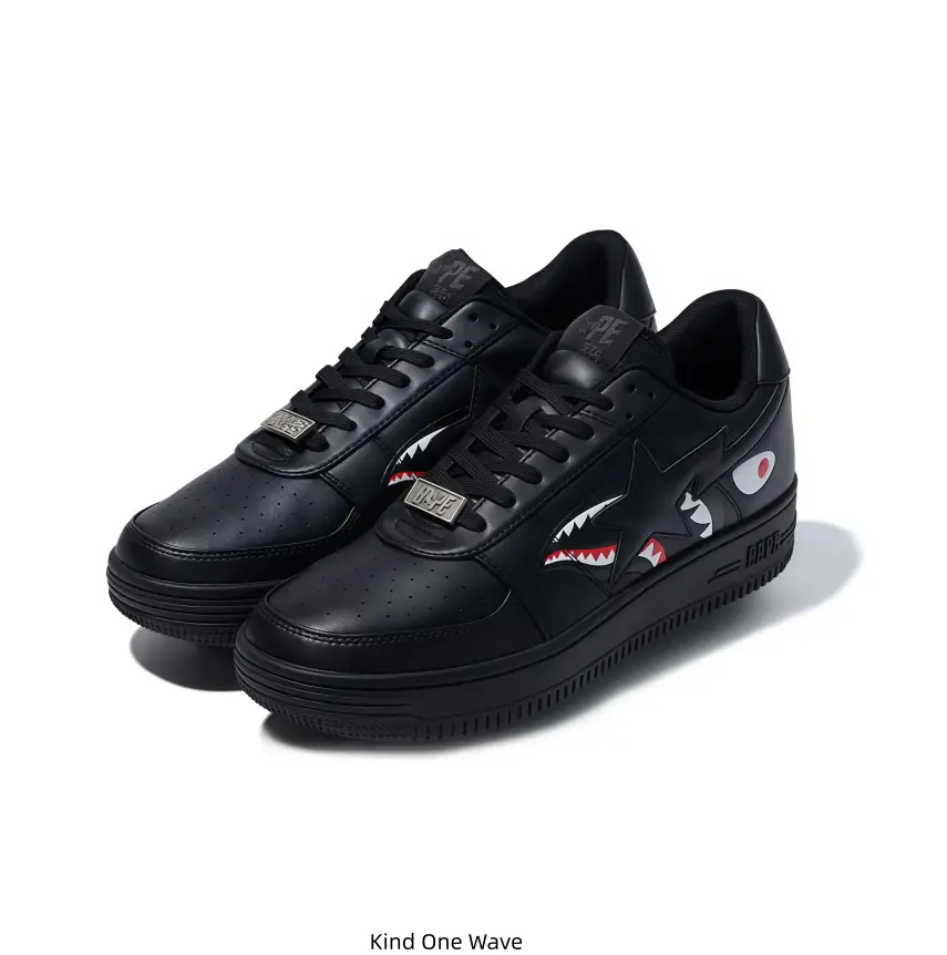 All-black leather BAPE STA low-top sneakers featuring classic shark mouth graphic detailing on the side, mastermind lettering printed on the heel, sleek dark street styling ideal for sneaker collectors and versatile daily casual outfits