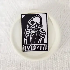 1PCS punk style STAY POSITIVE embroidered patch with skull and thumbs up action design badges, suitable for DIY decorative patches on hats, bags, shoes, and clothing, durable material with back hot melt adhesive that can be sewn, ironed, and washed