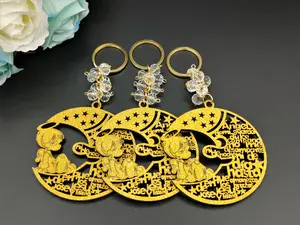 US 12pcs Gold Glittle Angel Boy in the Moon Design Laser Cutout Keychain Baptism Favors with Boy Angel Recuerdos de Bautizo With Organza Bags