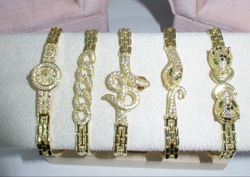 Elegant Gold-Tone Bracelets with Sparkling Animal Heads Green Stone Accents Snake-Inspired Shapes Classic Chain Motif Round Pavé-Style Medallion