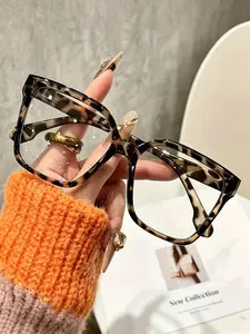 A pair of large square transparent glasses, bohemian style, designed for women, equipped with stylish leopard print and solid colors, using PC polyester material, designed with a full frame.