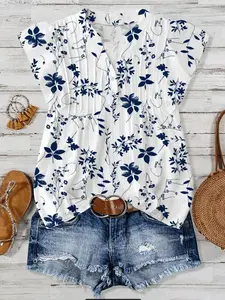 A women's fashionable French retro blue and white floral print top with pleated V-neck loose and slimming fly sleeves, suitable for summer, island travel, summer dates, vacation photos, parties, and commuting.