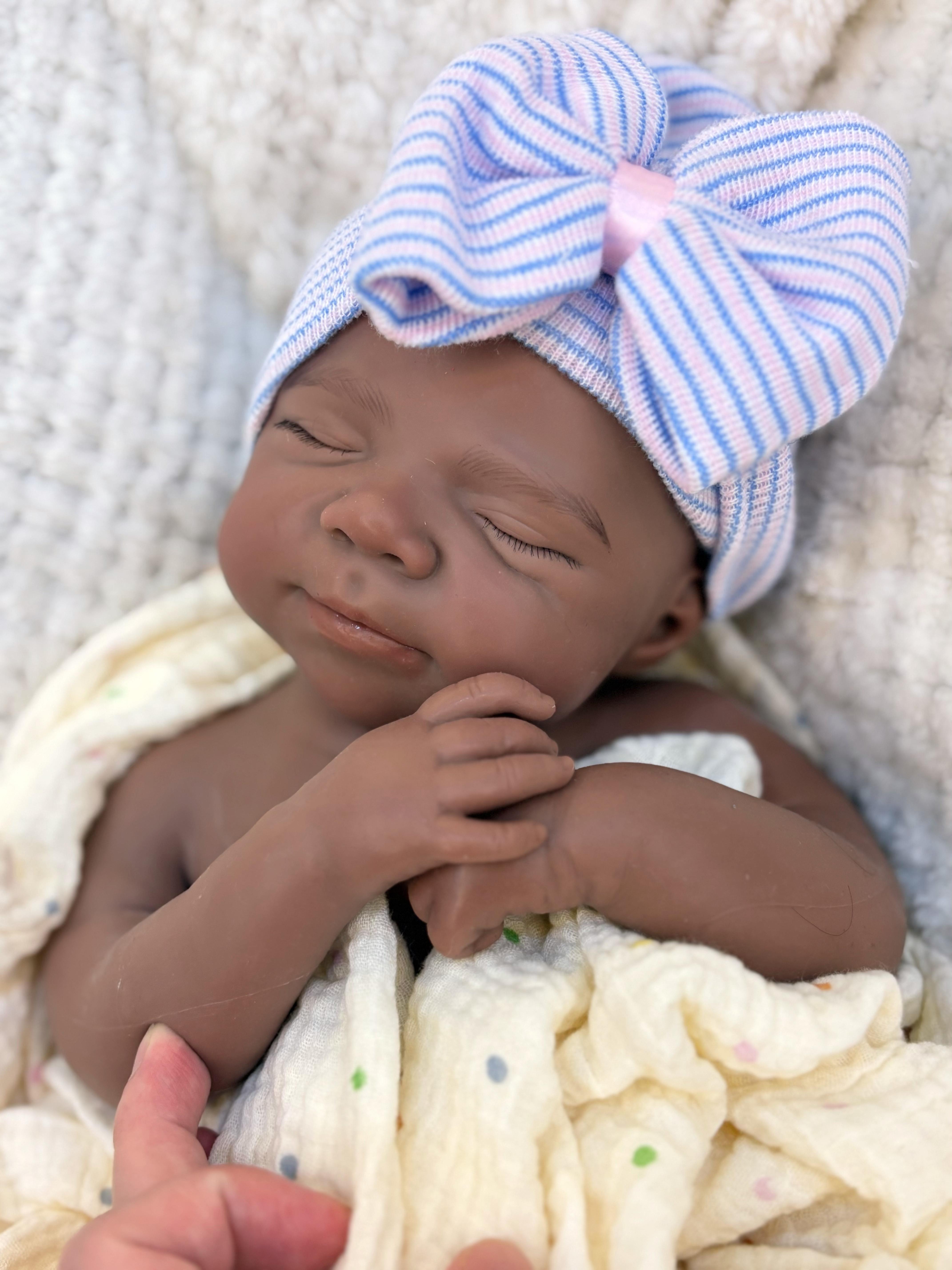 Reborn doll, soft silicone — 18 inches tall, lifelike with closed eyes for sleeping, brown skin, a soft body, and realistic detailed features. Includes a comfort item, a bottle, and a birth certificate. Perfect for birthday gifts, collectors, and children