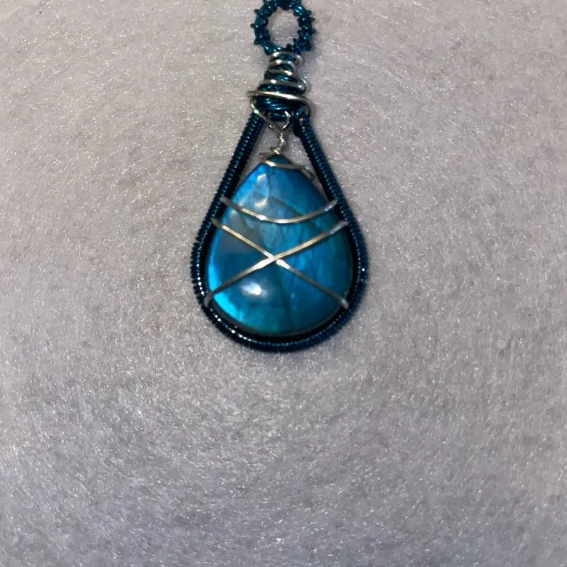 Blue labradorite wrapped in blue and silver wire.