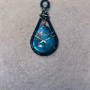 Blue labradorite wrapped in blue and silver wire.