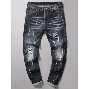 Men’s street retro-style spray paint print distressed ripped button-fly jeans—casual, comfortable denim pants with pockets for everyday wear; fashionable men’s bottoms suitable for all seasons.