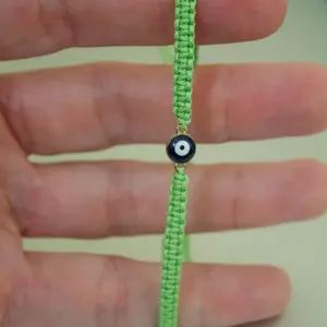 Handwoven Green Macrame Bracelet with Evil Eye Charm - Handcrafted Adjustable Wristband for Everyday Wear