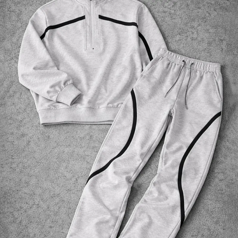 Men’s half-zip couple set featuring a printed zip-up top with matching leggings; loose, casual street style; coordinated outfit; complete athletic tracksuit set.
