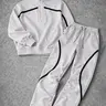 Men’s half-zip couple set featuring a printed zip-up top with matching leggings; loose, casual street style; coordinated outfit; complete athletic tracksuit set.