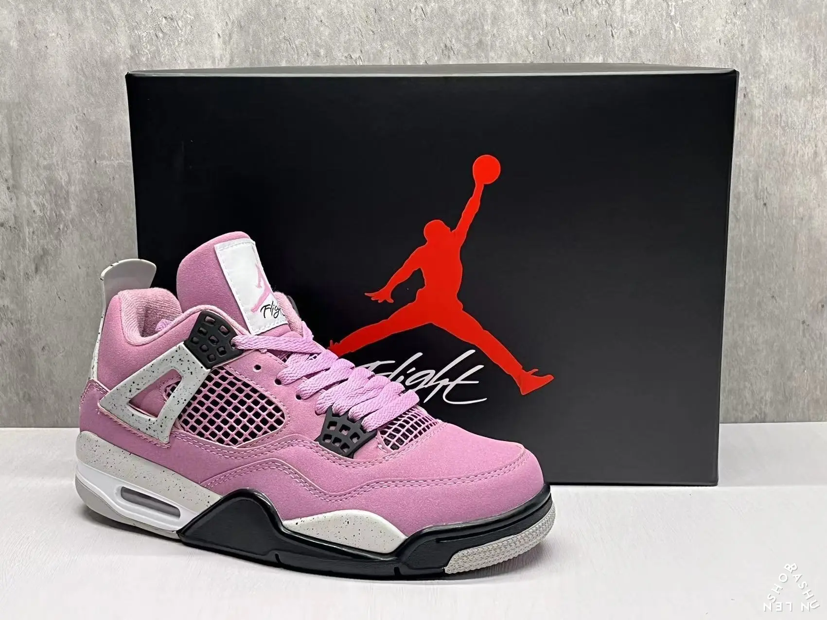 Pink and Black Mid-Top Retro Basketball Shoe with Suede Upper, Mesh Panels, Black Accents on Midsole and Heel, and Translucent Rubber Outsole with Sawtooth Pattern