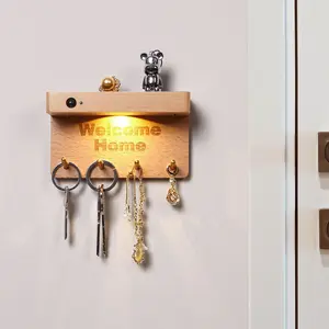 Magnetic wall-mounted hook rack with a motion-sensor light; features wooden hooks, a motion-sensor light, and a key storage compartment; made of solid wood; perfect for entryways, bedrooms, and hallways