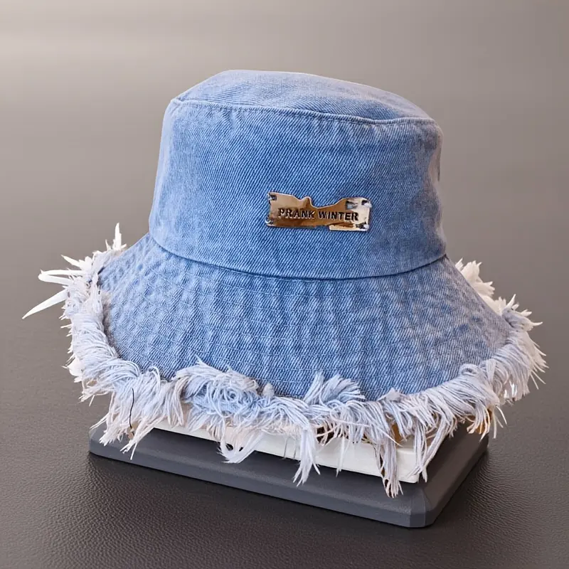 Fashionable washed denim bucket hat for women—a trendy, comfortable sun-protection cap with tassel trim, ideal for beach outings and outdoor casual wear.