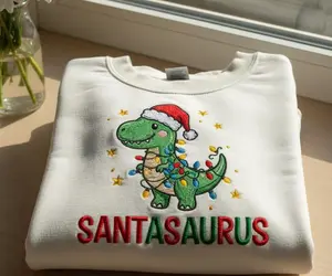 Embroidered Dinosaur Christmas Sweatshirt, Santasaurus Holiday Crewneck, Funny Xmas Embroidered Gift