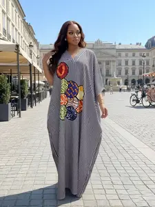 Blue and white vertical stripe printed loose robe African Kraft Tanzania plus size women's V-neck bat sleeve design with drooping fabric for slimming, lazy and fashionable daily vacation. Colorful printed design on the chest