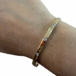 14K Gold Bangle with Unique Design Featuring Delicate Diamond Accents for Elegance