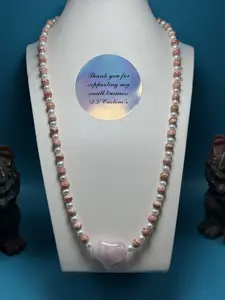 Stunning rhodochrosite and freshwater pearl accented with a beautiful rose quartz heart necklace.
