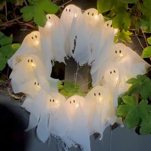 a halloween glowing ghost wreath, a halloween ghost gang knocking on the door, a cute yet thrilling halloween home door and window decoration pendant, a handicraft that easily creates a halloween atmosphere