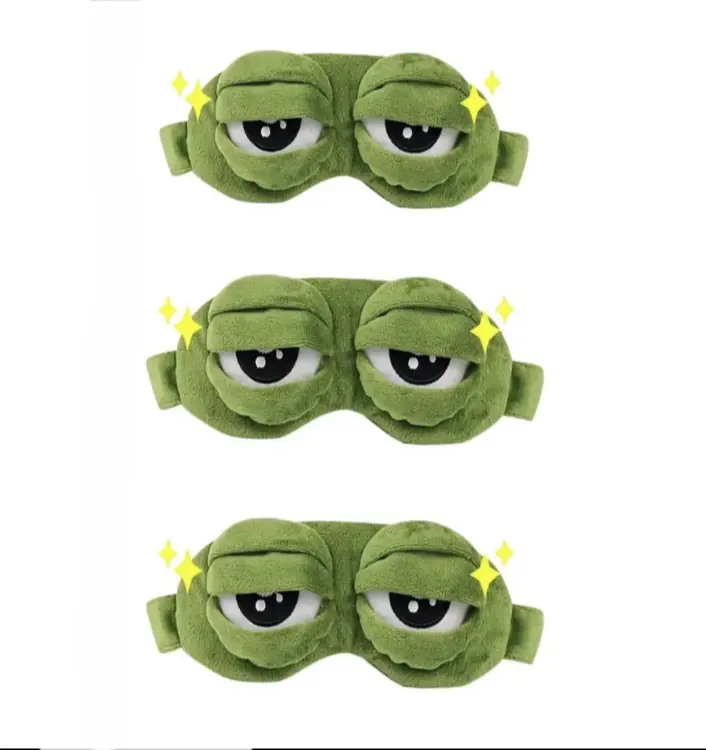 Frog Sleep Mask — A stylish, shimmering sleep mask featuring an adorable "Sad Frog" design. This fun, plush eye mask is perfect for travel, yoga, napping, and light-blocking; its soft cotton lining gently cares for sensitive skin.
