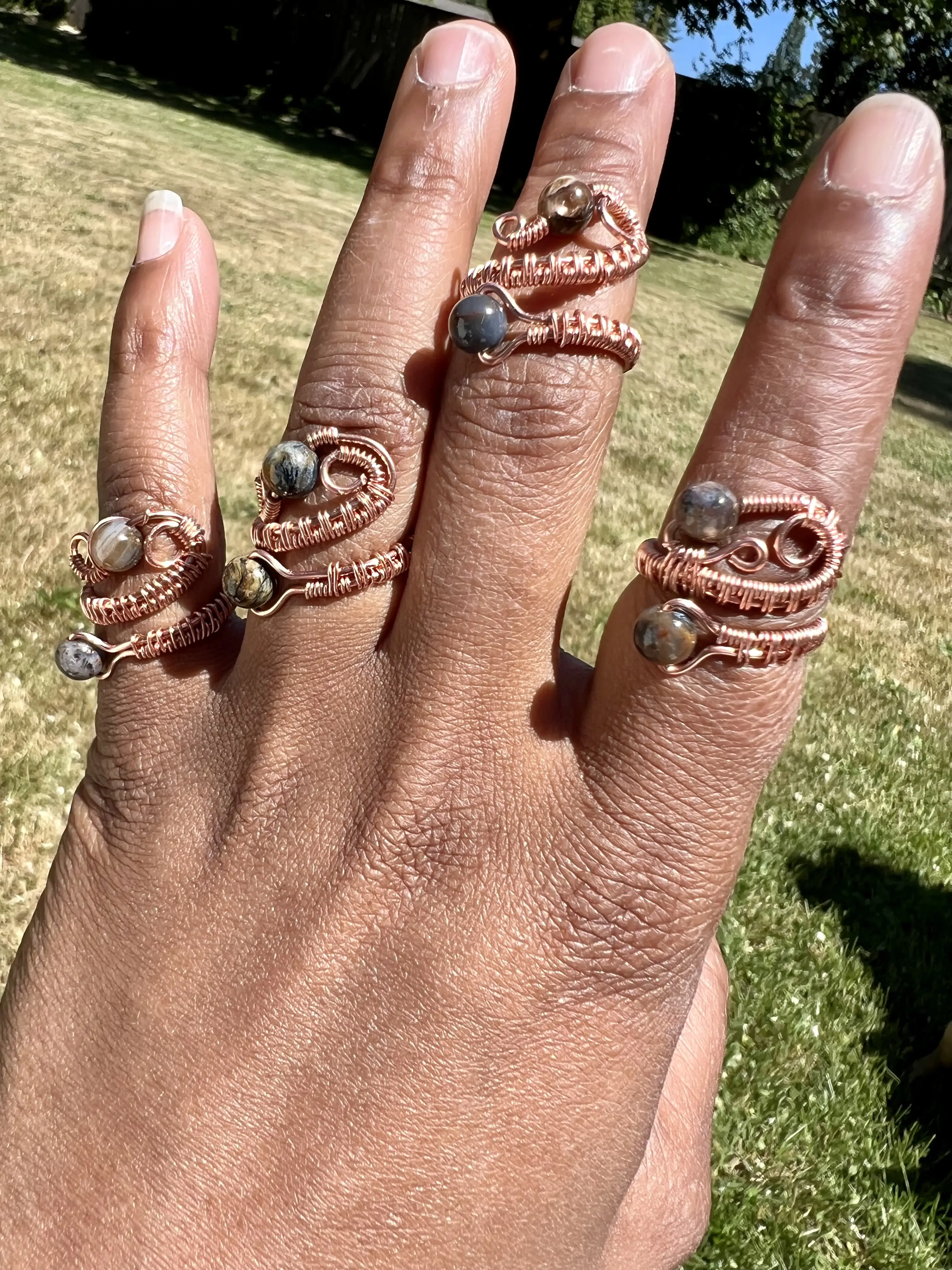 Adjustable Helix Gem Rings. Materials: Bare copper, pietersite, natural gemstones, ethically sourced
