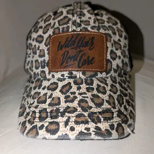 Cheetah print hat with ponytail opening in the back.  "Wild Hair Don't Care" design.